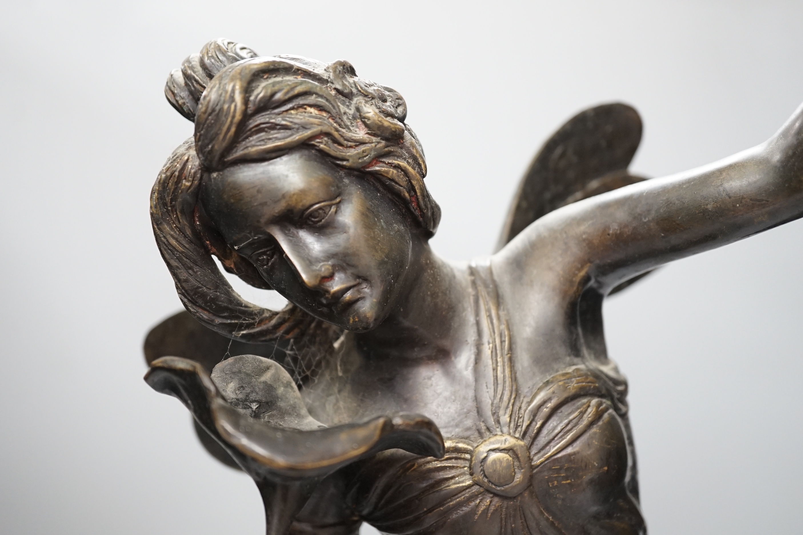 An Art Nouveau style fairy on a black marble base, 63.5cm high
